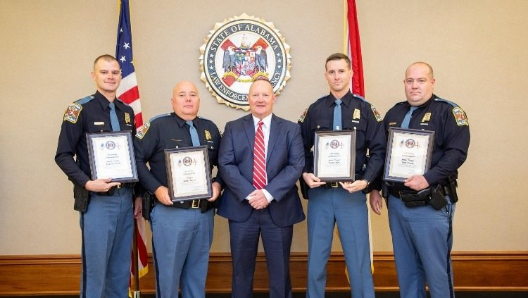 A group of officers standing next to each other holding certificates.