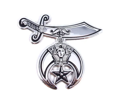 Silver sword and crescent emblem with a face and star pendant on a white background