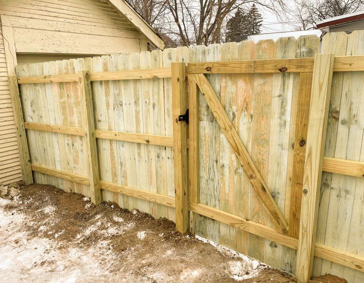 MI, durable winter  wood backyard fence installation.