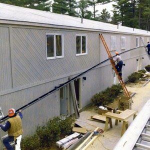 Worker Climbing The Ladder — Raymond, ME — The Gutter People