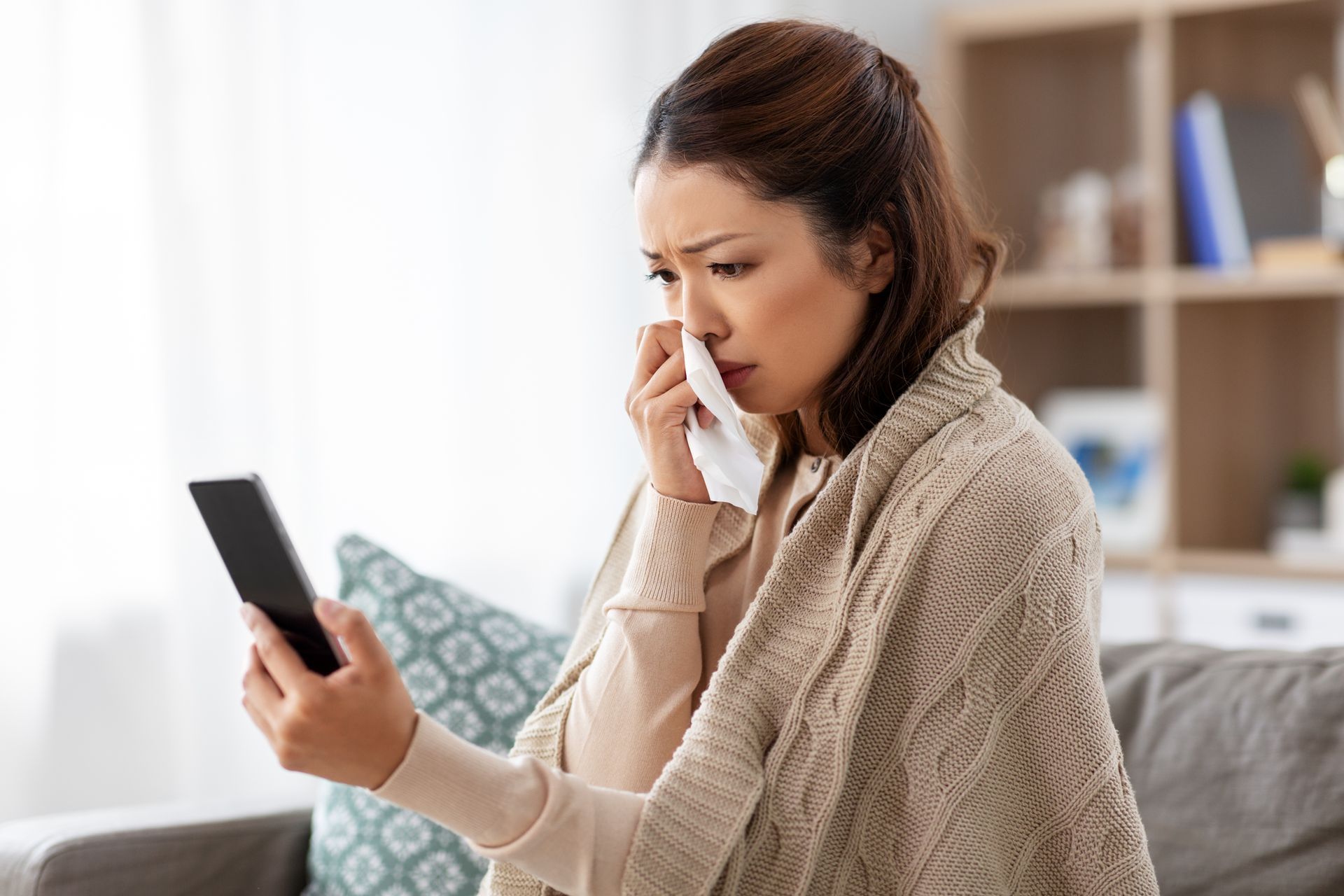 A woman checking pollen count during allergy season.