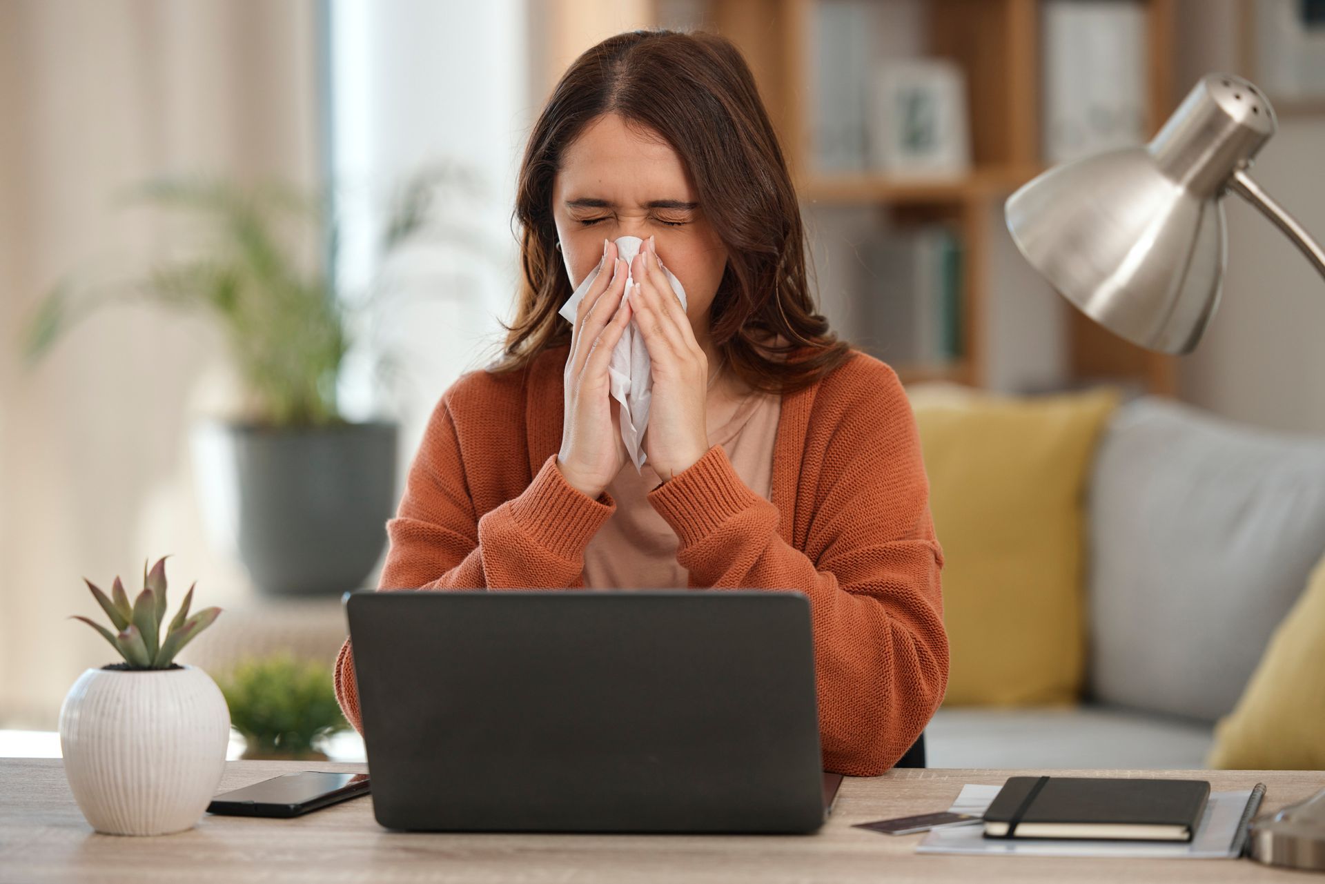 A woman with persistent allergies blows her nose, searching for allergy treatment options that work.