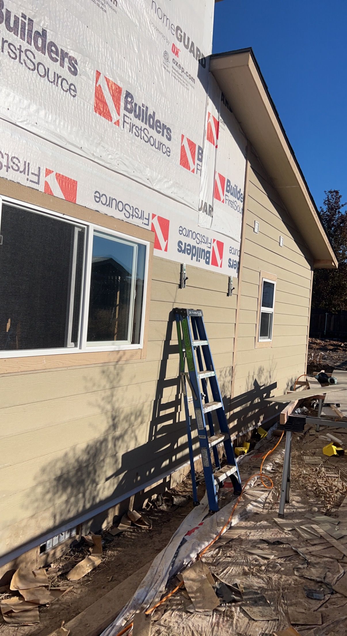 A patio with a couch , chairs , and a grill.