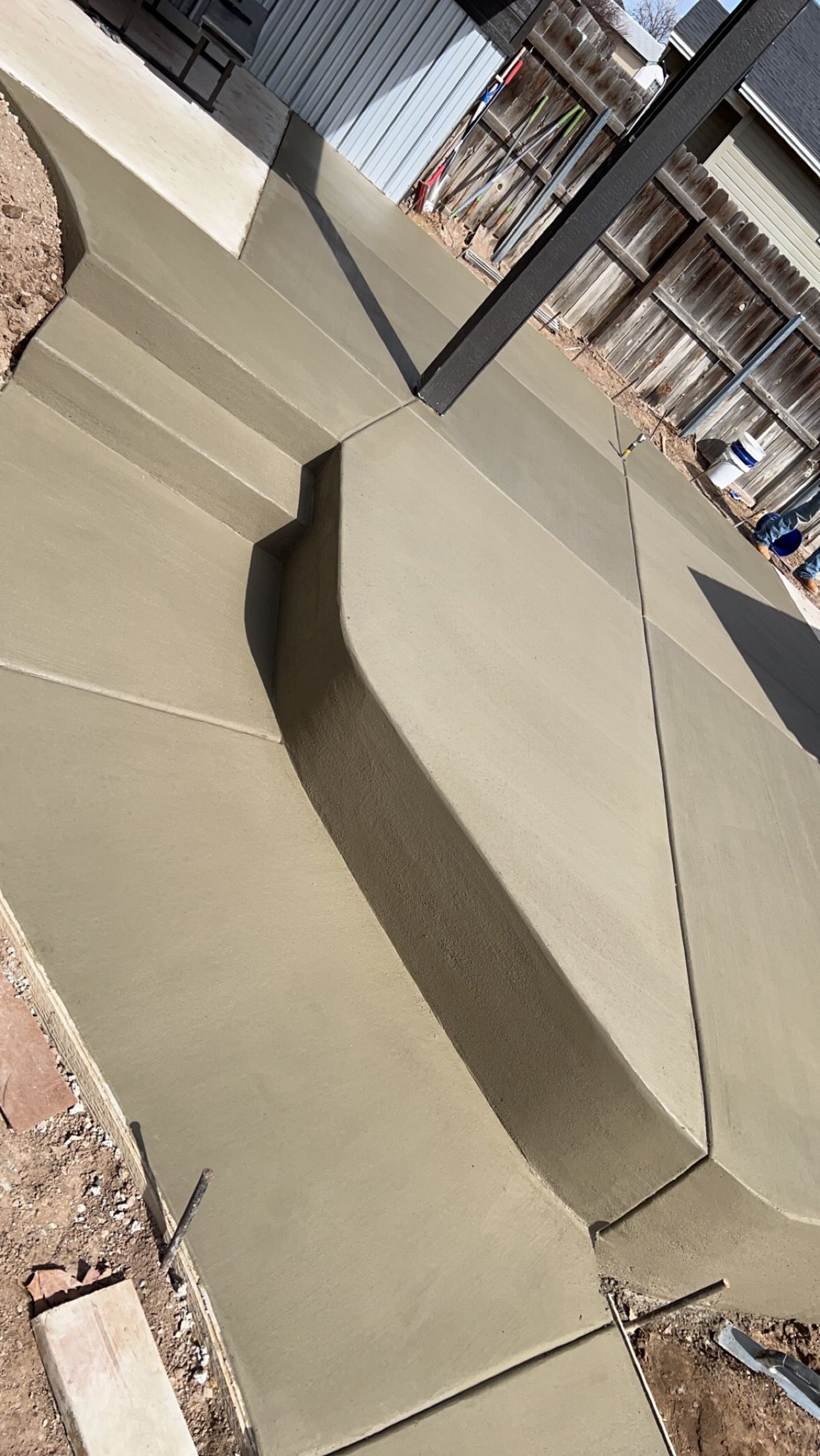 A living room with a couch and a brick wall.