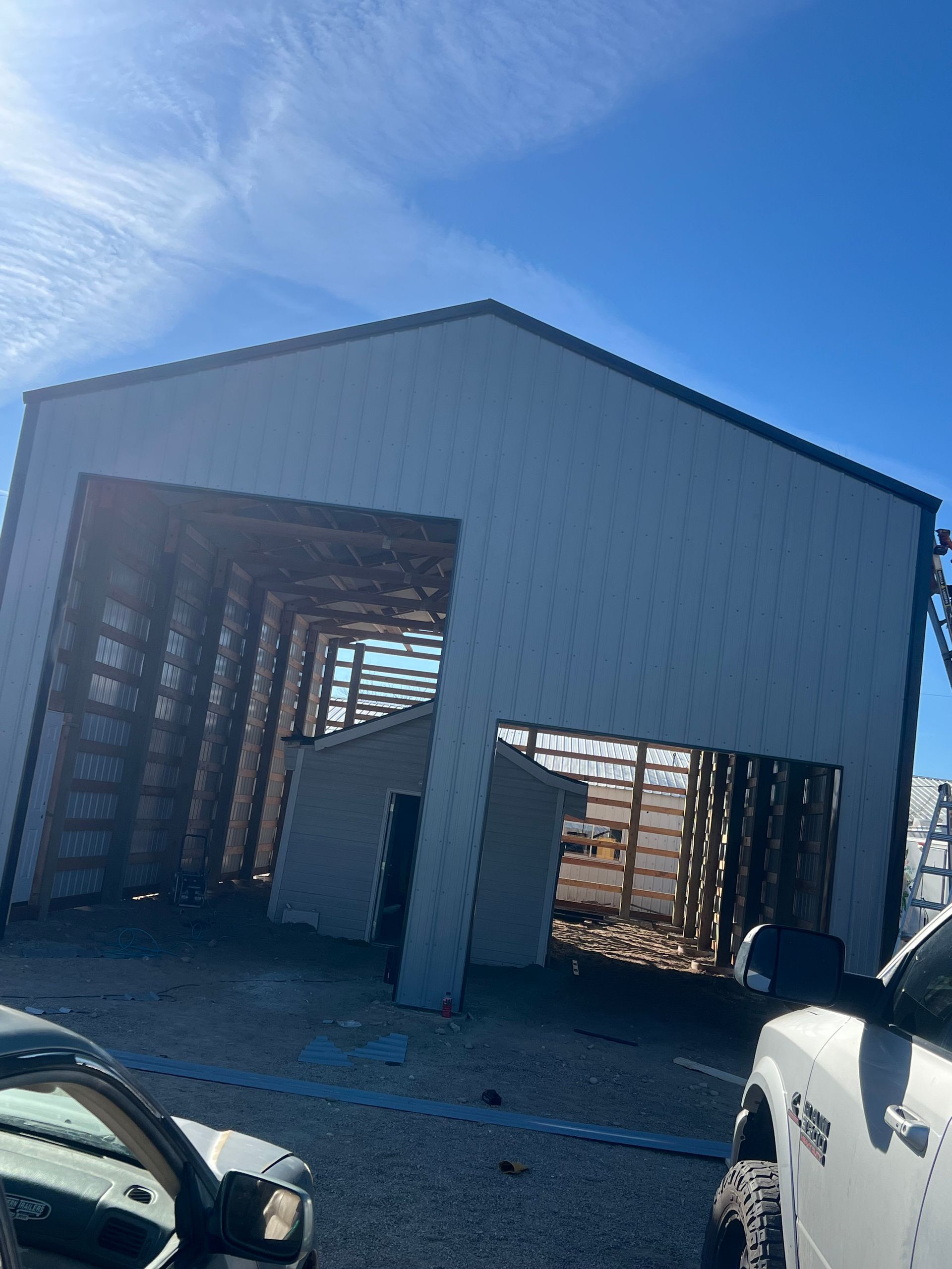 A living room with a couch , chairs , a grill and a television.
