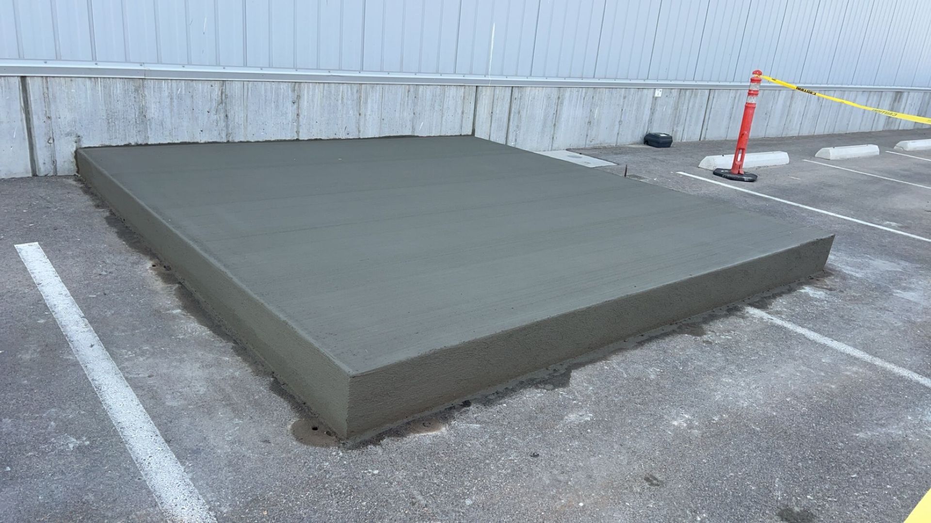 A close up of a black tile floor with a white tile in the corner.