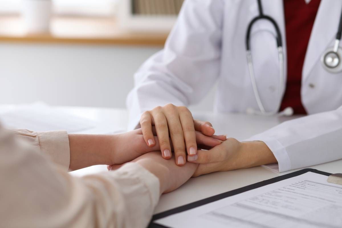A concierge medicine provider clasping hands with a patient near Lexington, Kentucky (KY)