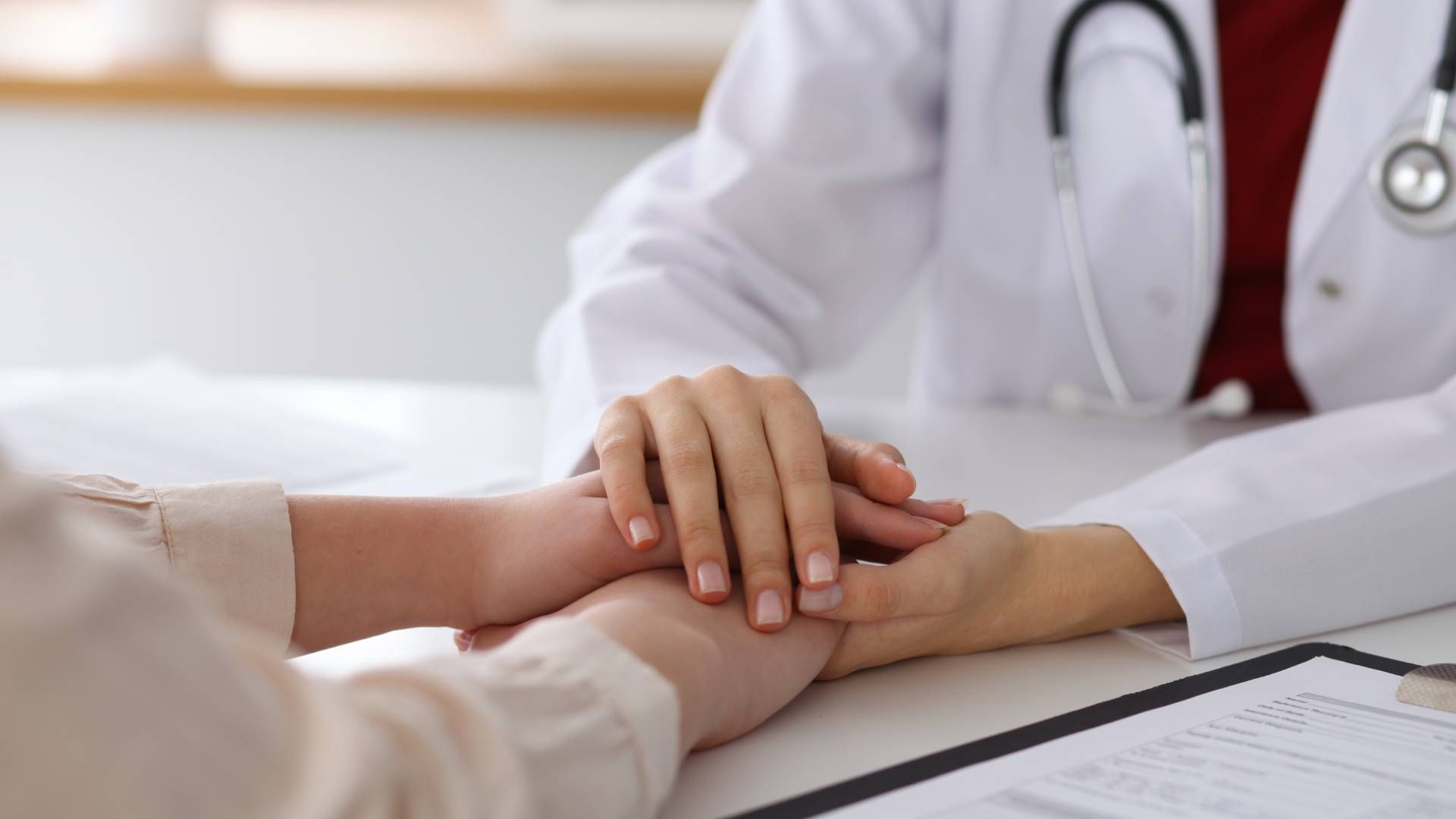 A concierge medicine provider clasping hands with a patient near Lexington, Kentucky (KY)