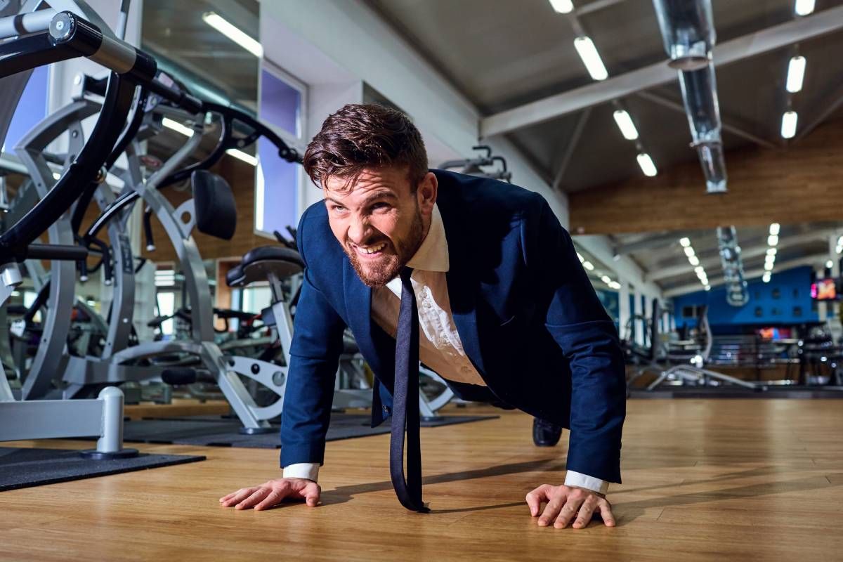 A businessman doing push-ups from the floor in the gym near Lexington, Kentucky (KY)