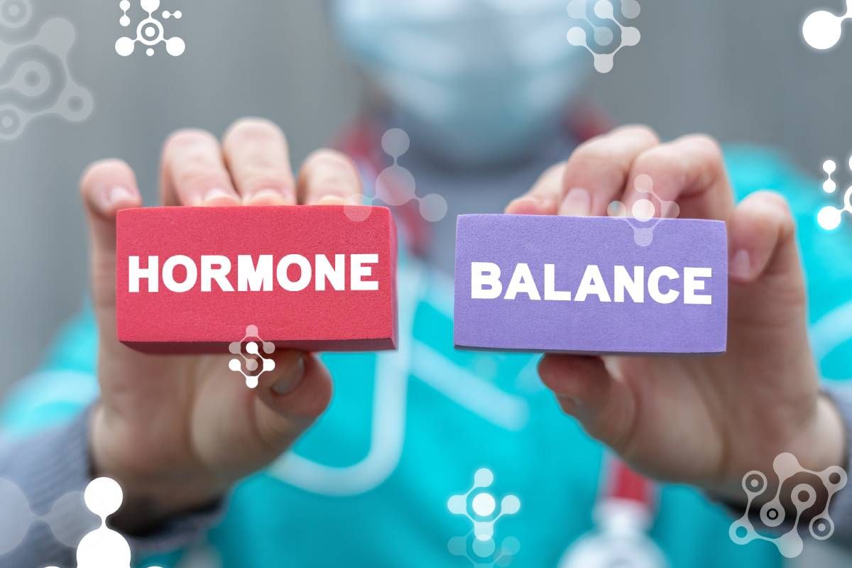 A doctor holding up two blocks representing hormone balance near Lexington, Kentucky (KY)