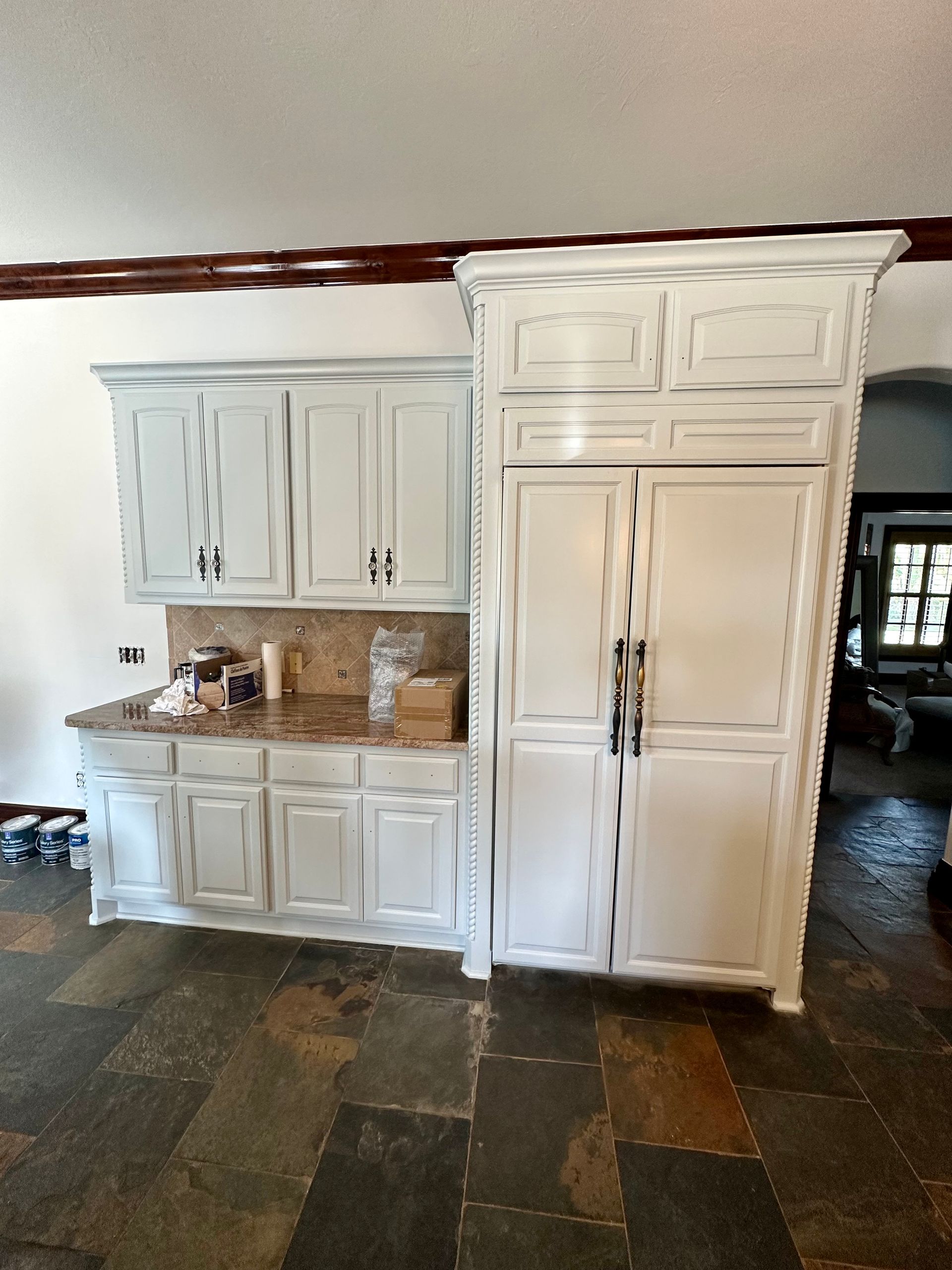 A kitchen with white cabinets and granite counter tops