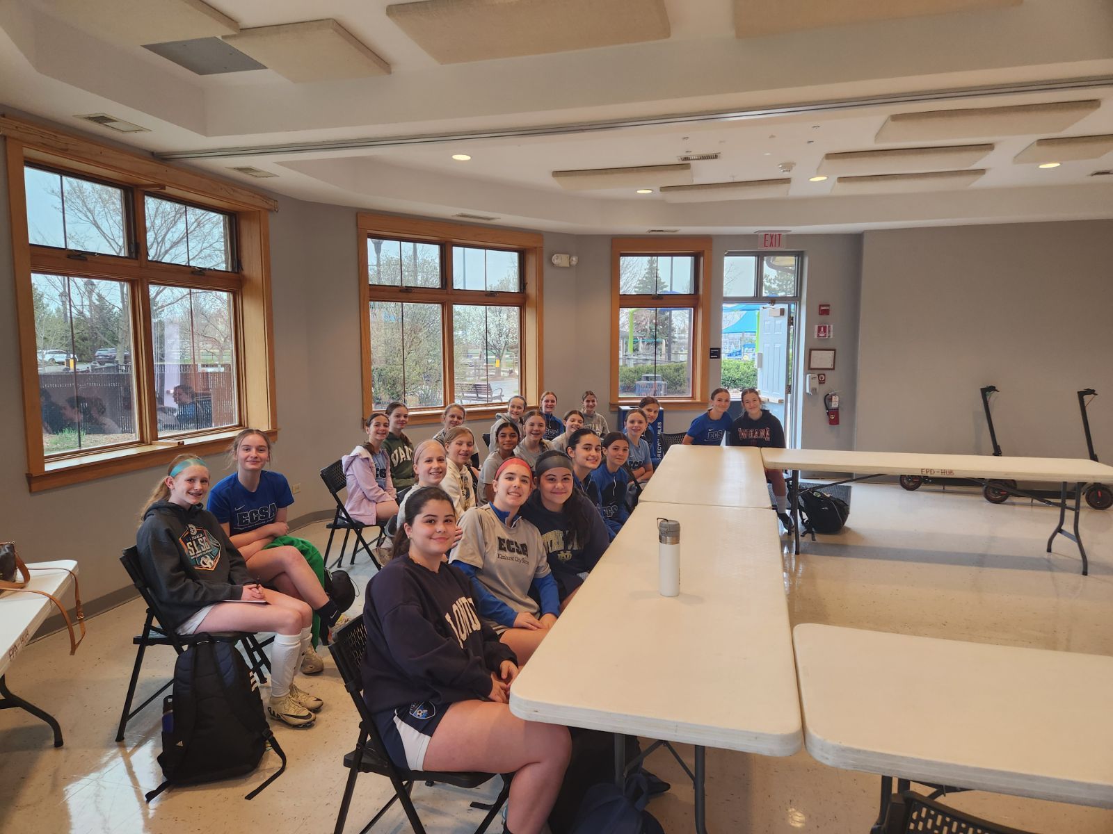 A group of people are sitting at tables in a room.