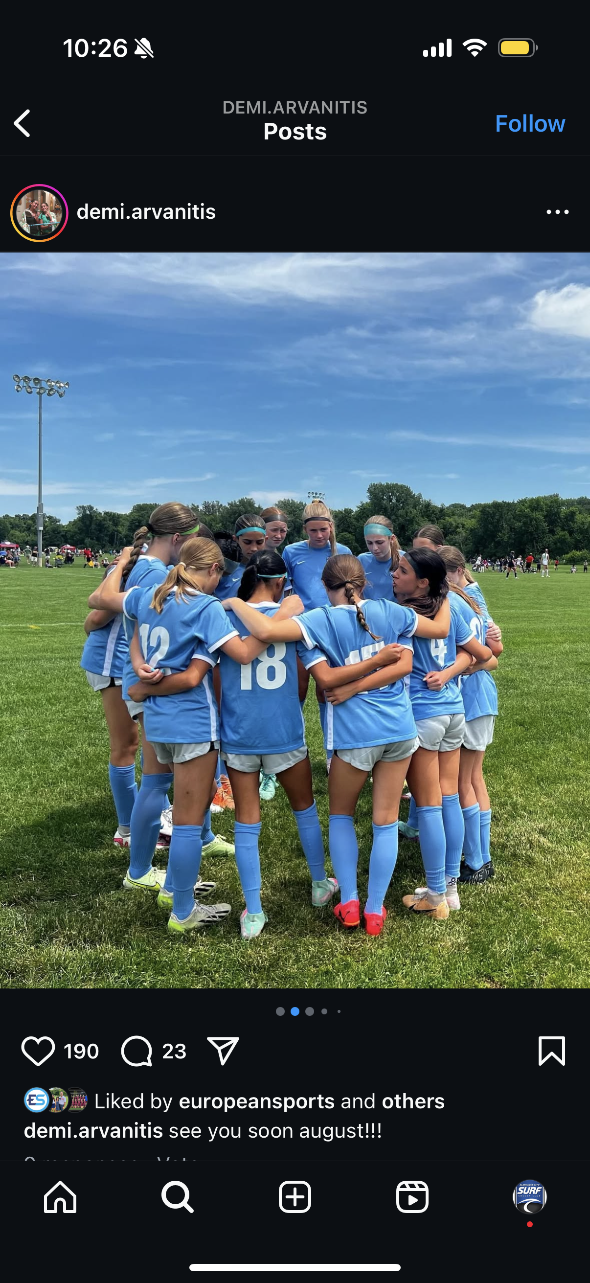 A group of soccer players are huddled together on a field.