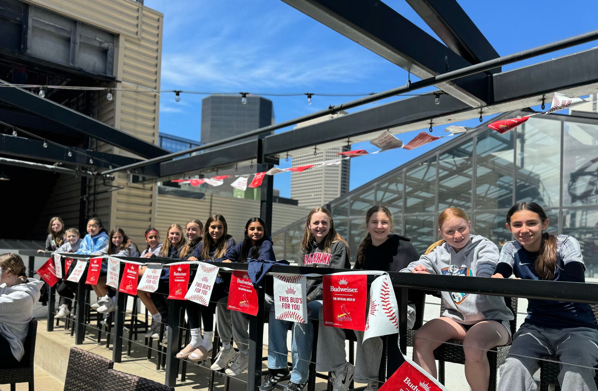 A group of young girls are sitting at a table with flags.