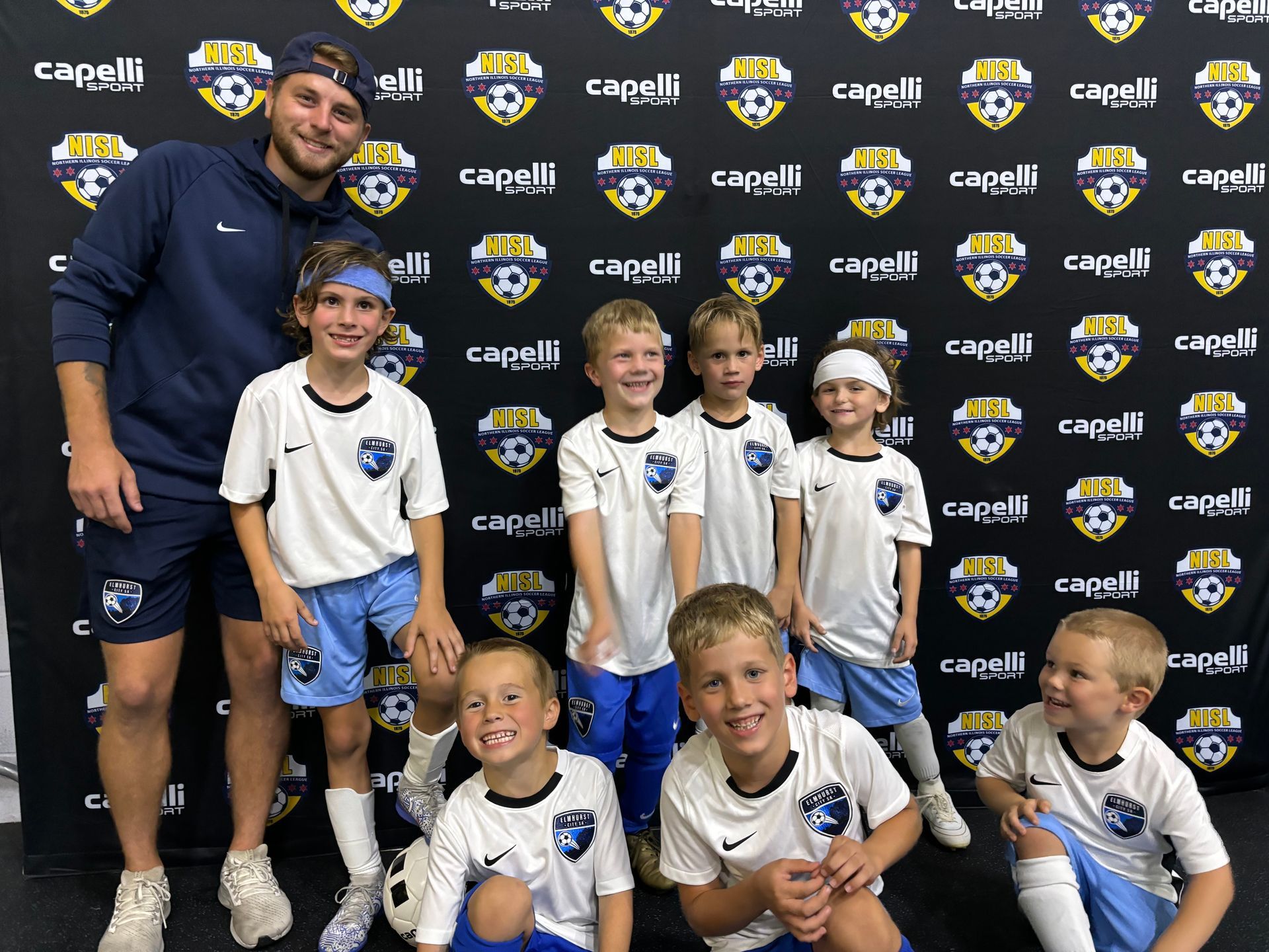 A group of young boys are posing for a picture with their coach