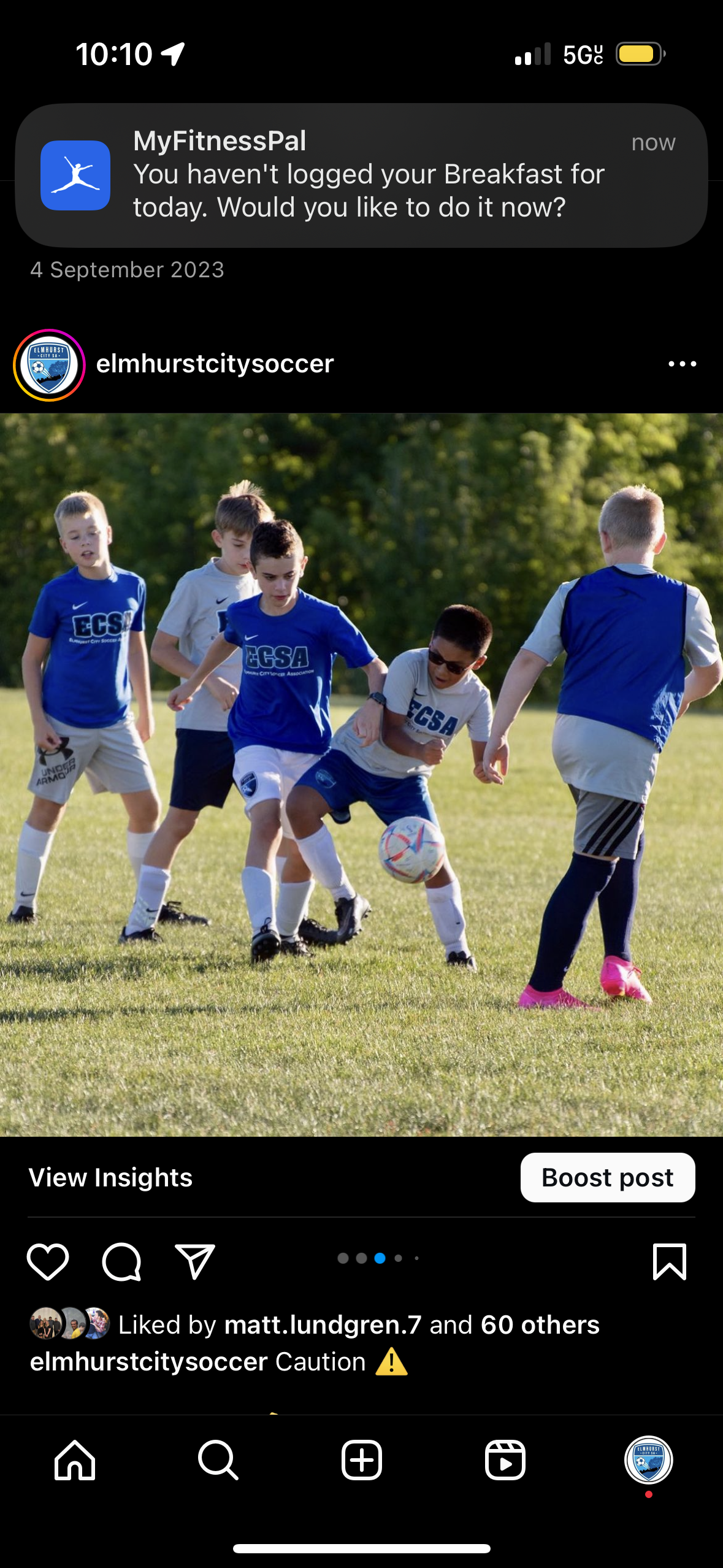 A group of young boys are playing soccer on a field.
