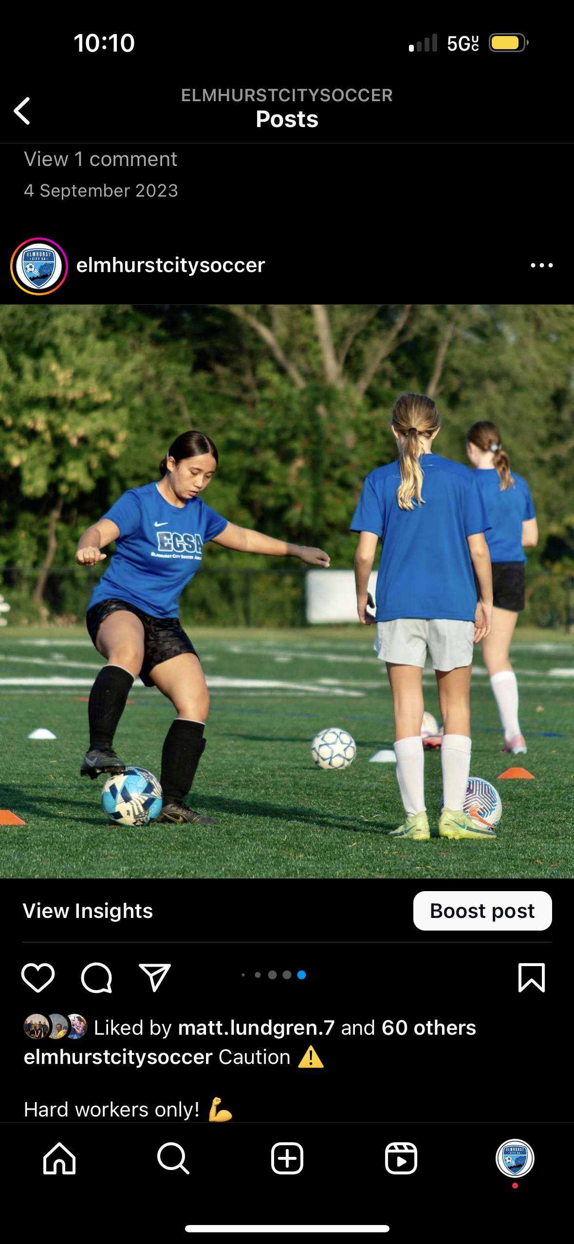 A group of girls are playing soccer on a field.