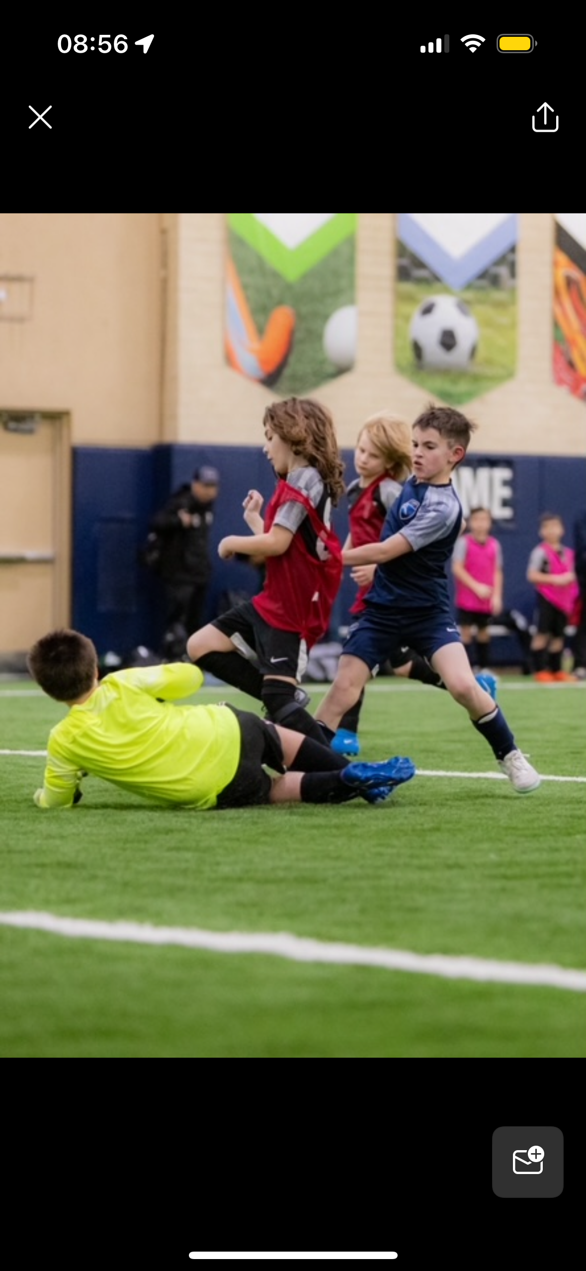A group of young boys are playing soccer on a field.