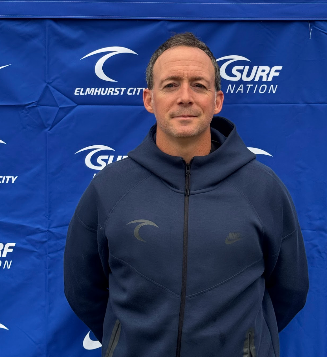 A man with a beard is taking a selfie in a hotel room.