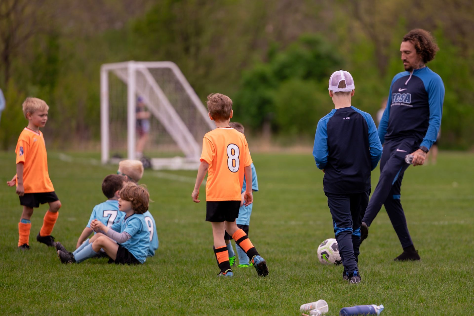 A group of young boys are playing soccer on a field.