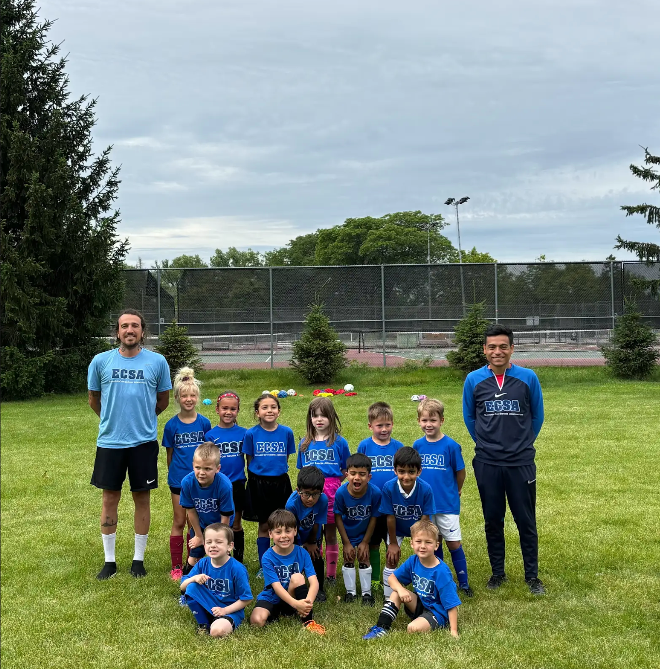 A group of children are posing for a picture in a field.
