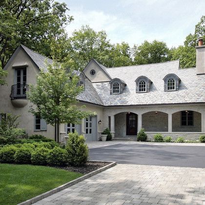 A large house with a lot of windows and a driveway