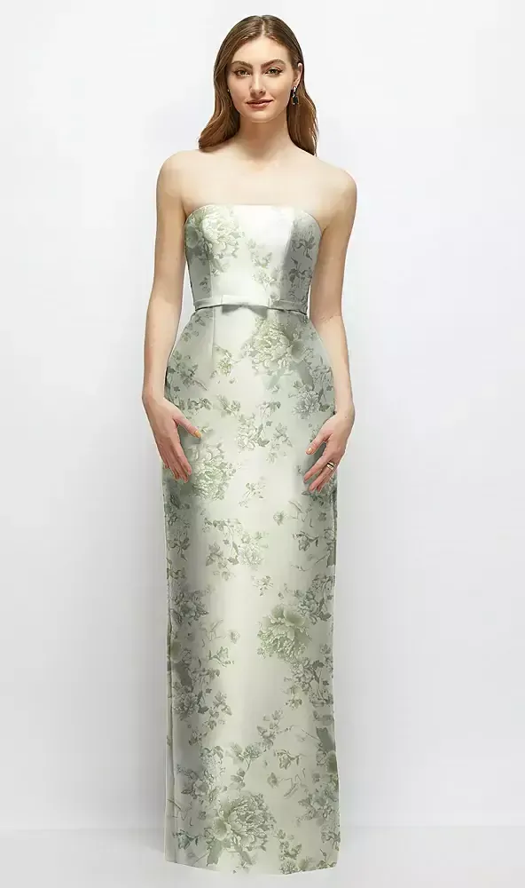 A woman is wearing a strapless dress with a floral print.