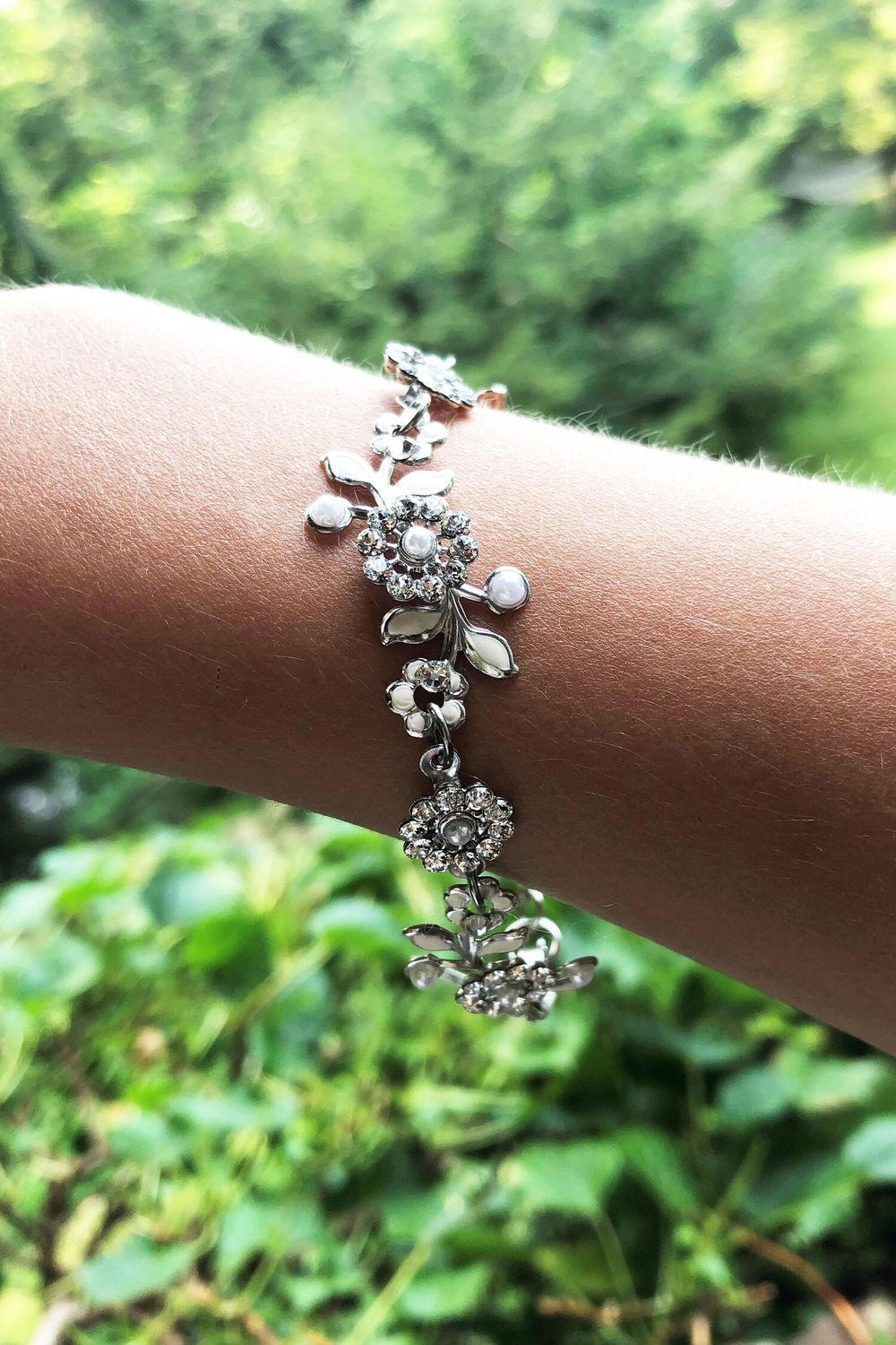 A woman is wearing a bracelet on her wrist.