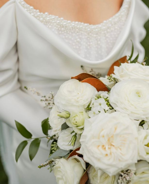 A woman is trying on a wedding dress in a bridal shop.