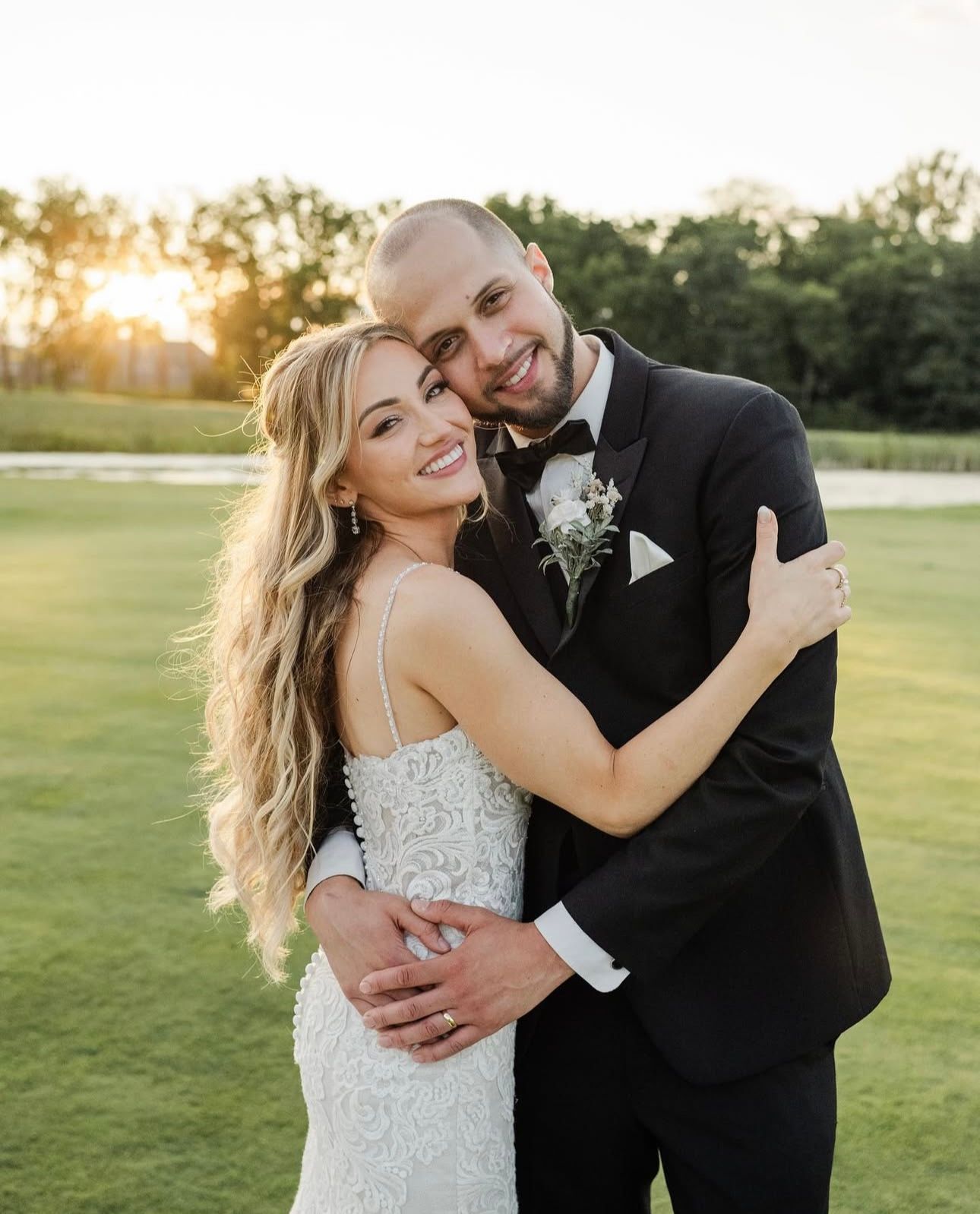 A bride and groom are posing for a picture on their wedding day.
