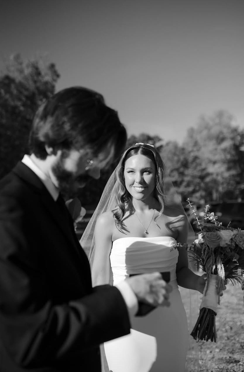 A black and white photo of a bride and groom