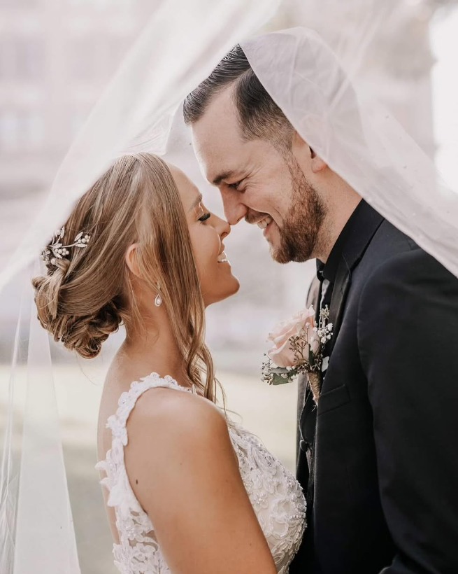 A woman in a wedding dress is laying on a set of stairs.