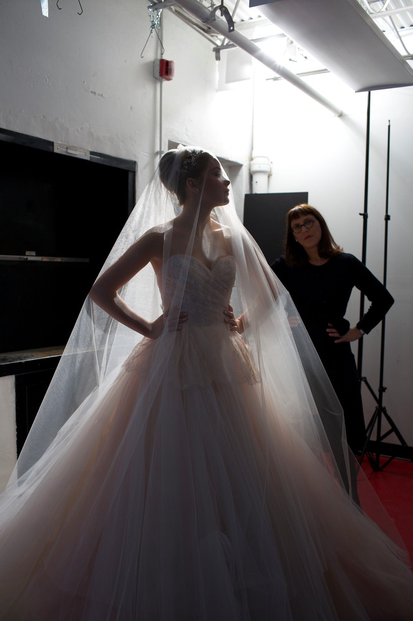 A woman is standing next to a woman in a wedding dress