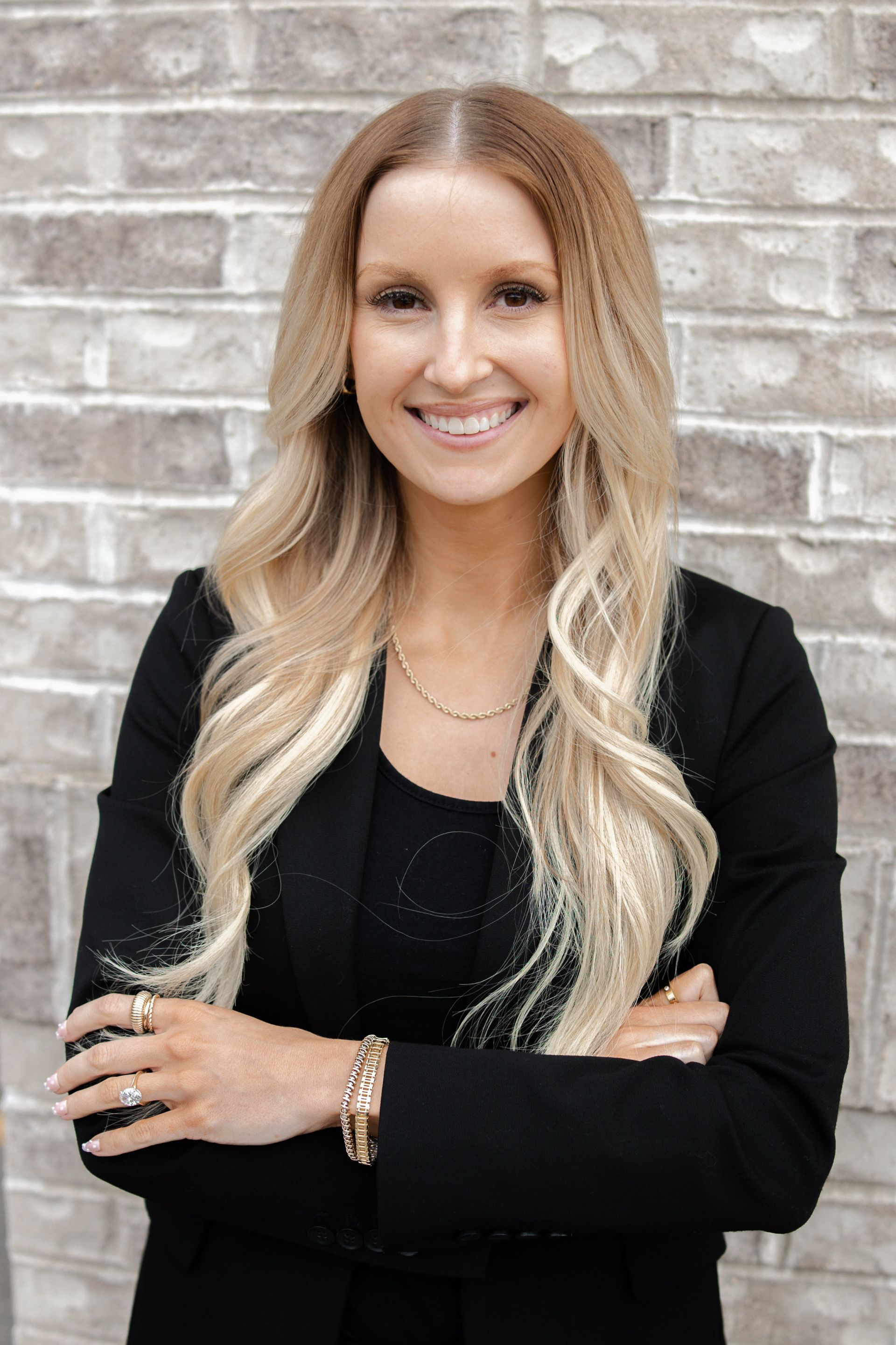 A woman in a white shirt is holding a book on her head.