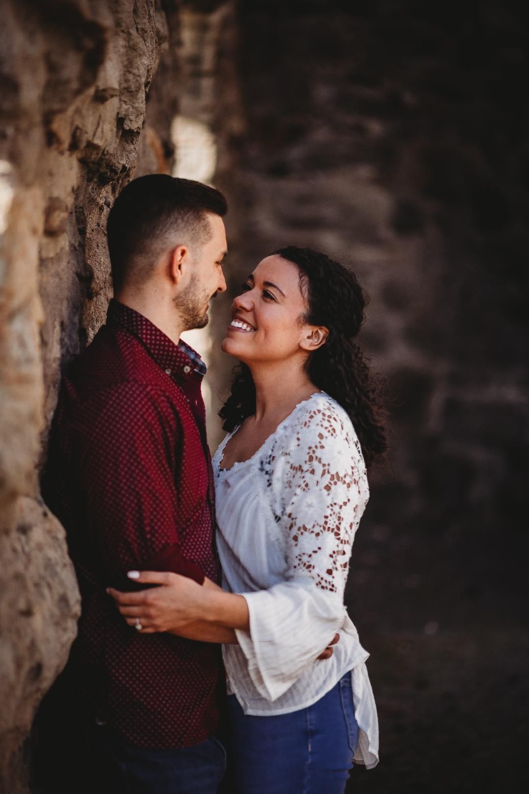 A man and a woman are standing next to each other and looking at each other.