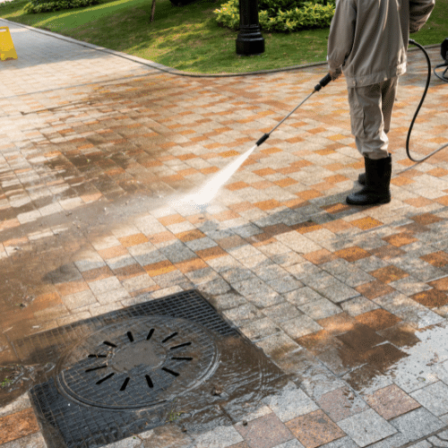 Worker using high pressure hose