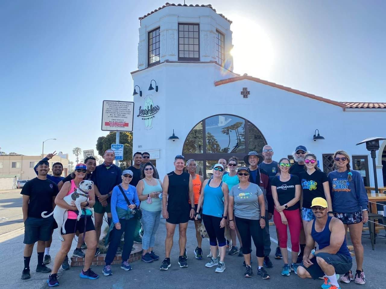 A group of people are posing for a picture in front of a building.