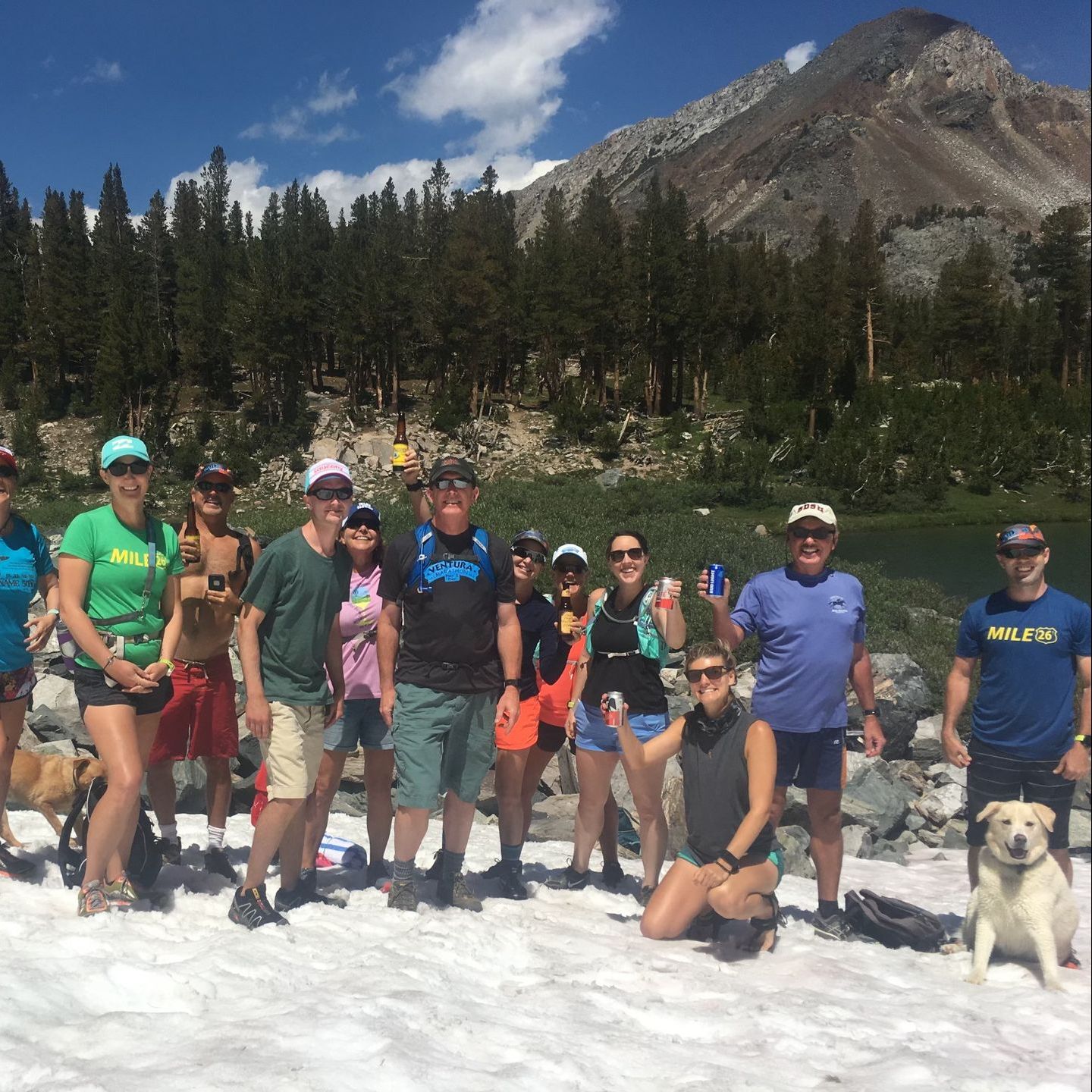 A group of people posing for a picture with one man wearing a shirt that says half fix