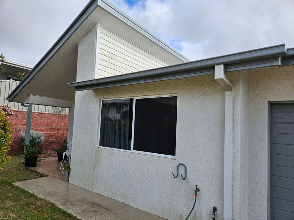 A white house with a garage and a large window. — O & D House Wash & Cleaning Services in Oakey, QLD