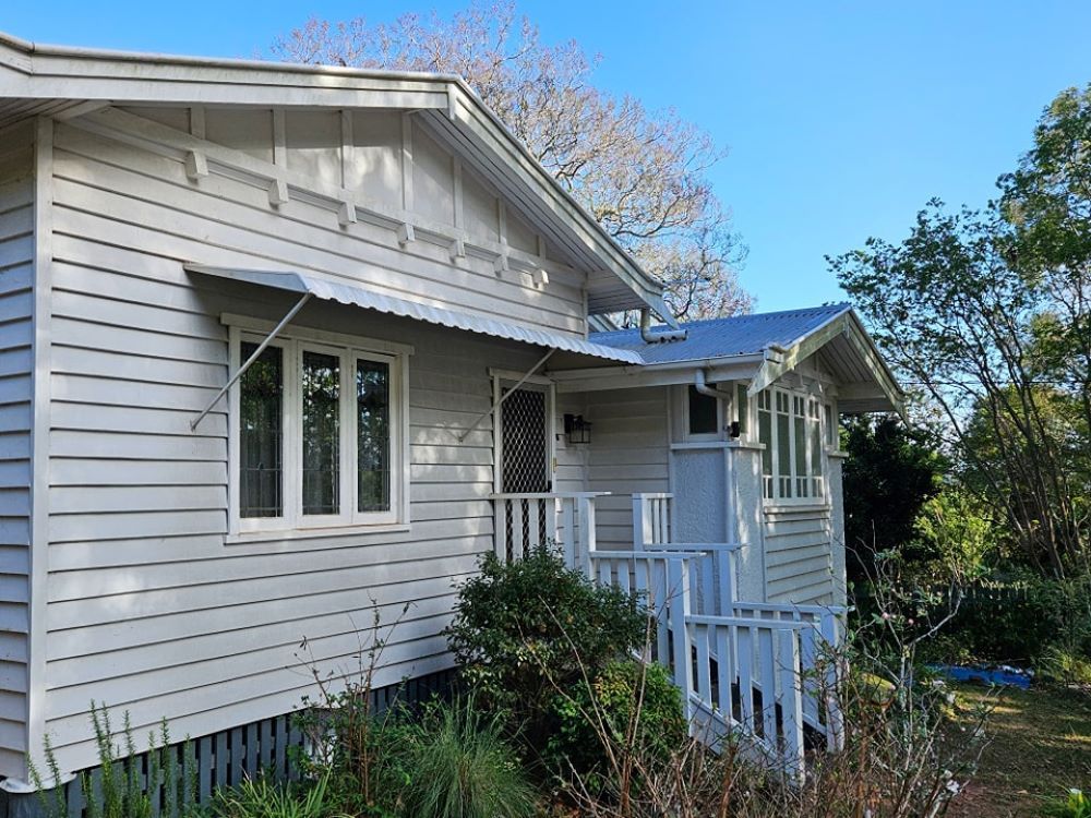 A White House With a Blue Sky in the Background — O & D House Wash & Cleaning Services in Oakey, QLD