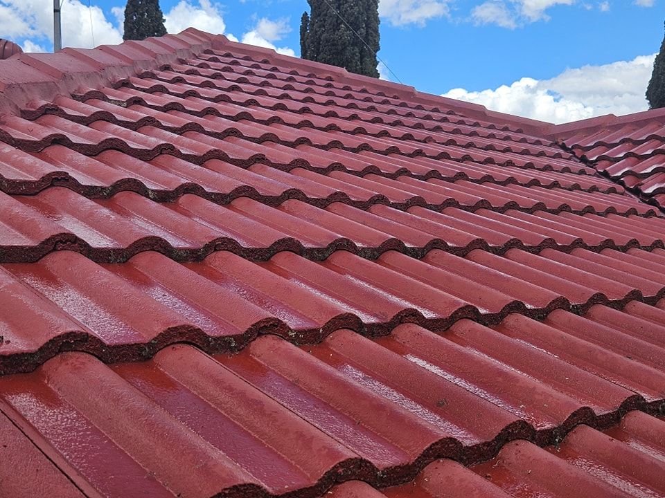 A close up of a red tiled roof with a blue sky in the background. — O & D House Wash & Cleaning Services in Pittsworth, QLD