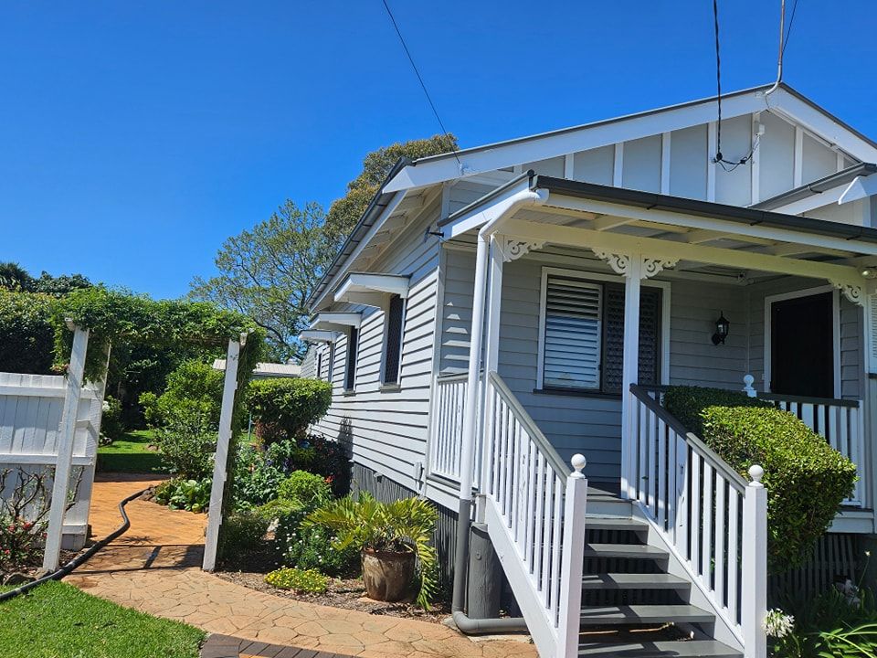 A White House With Stairs Leading Up to the Front Porch — O & D House Wash & Cleaning Services in Highfields, QLD