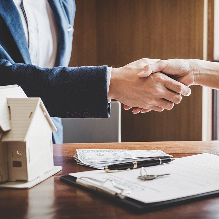 Home Insurance Agent Shaking Hands With Client