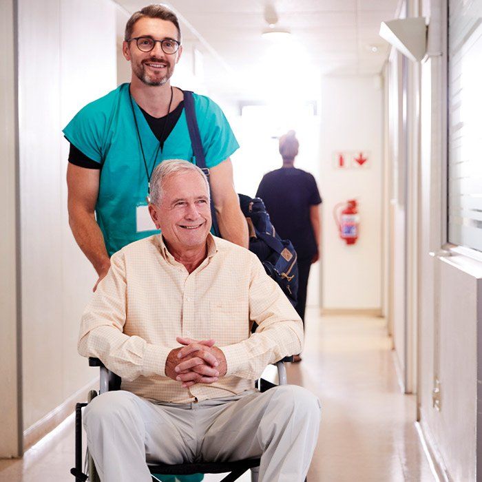 Physician Assisting His Patient on Wheelchair