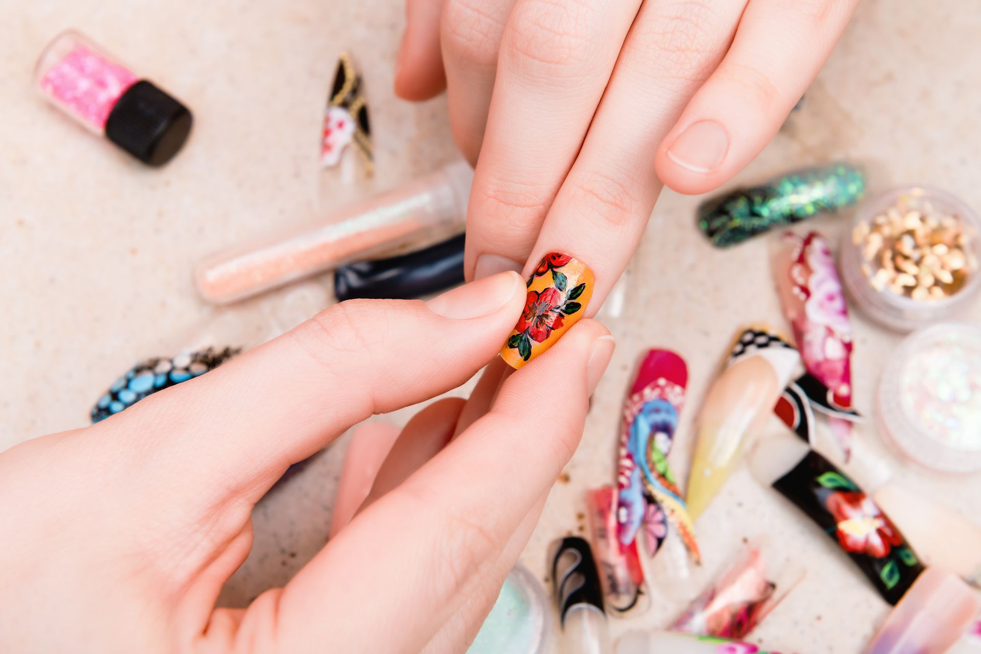 A woman is getting her nails painted by a nail artist.