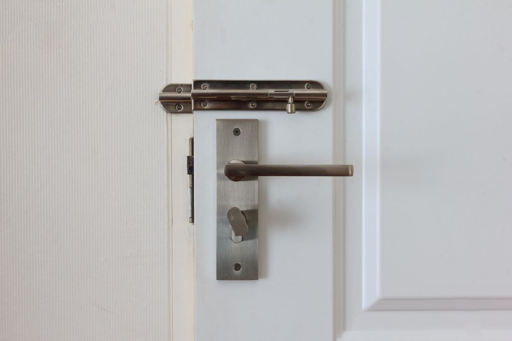 A Close Up Of A Door With A Door Handle And Lock — Dependable Locksmiths in Harrington, NSW