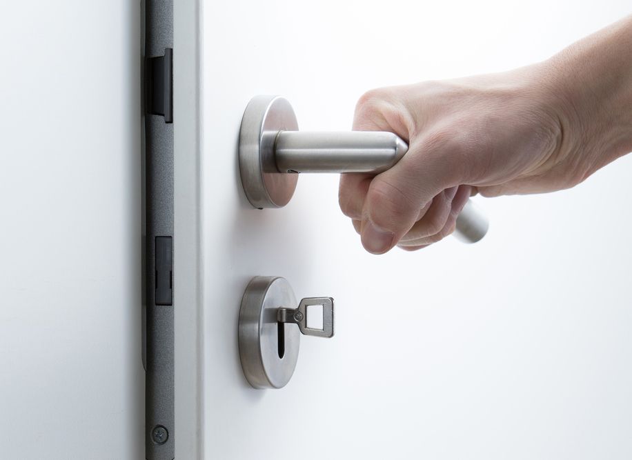 Person Is Opening A Door With A Key — Dependable Locksmiths In Wingham, NSW