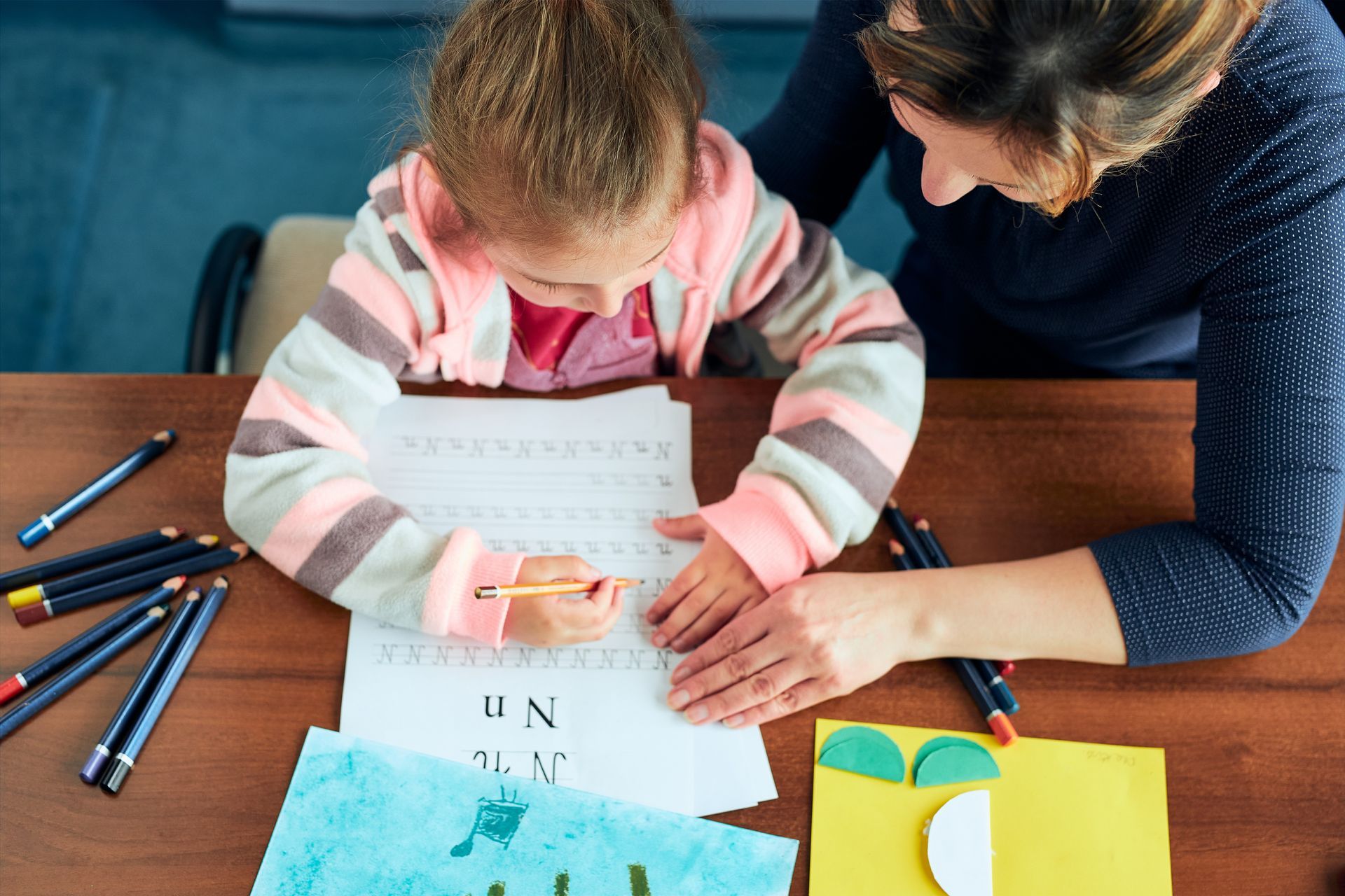 Little girl preschooler learning to write letters with help of her mother. Little girl preschooler learning to write letters with help of her mother.