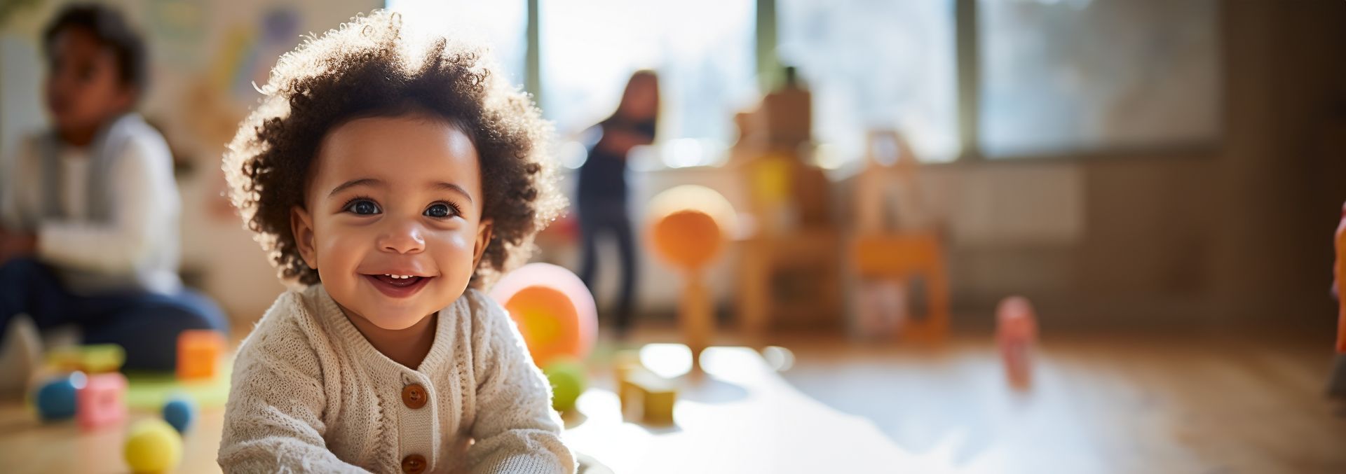 Happy toddler at a local child care agency playing with educational toys in a sunny classroom.