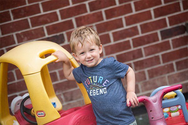 Boy Smiling at the Camera — Mokena, IL — Triple R Child Care